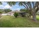 Lush backyard featuring a screened lanai, mature trees, and well-manicured landscaping at 12304 Freesia Ct, Riverview, FL 33569
