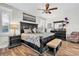 This primary bedroom features wood floors, a ceiling fan, and a large furniture set at 12304 Freesia Ct, Riverview, FL 33569
