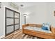 This is a clean guest bedroom space with hardwood floors and a murphy bed at 12304 Freesia Ct, Riverview, FL 33569