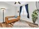 Cozy bedroom with a trundle bed, blue curtains, and wood-look floors at 12304 Freesia Ct, Riverview, FL 33569