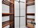 Custom closet with wooden shelves and metal clothing racks offering ample storage at 12304 Freesia Ct, Riverview, FL 33569