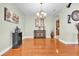 This dining room features light green walls, elegant lighting, and shiny, hard wood floors at 12304 Freesia Ct, Riverview, FL 33569