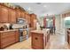 Well-equipped kitchen with stainless steel appliances, granite countertops, a center island, and a cozy breakfast nook at 12304 Freesia Ct, Riverview, FL 33569