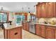 Modern kitchen with granite countertops, stainless steel appliances, and access to the outdoor pool at 12304 Freesia Ct, Riverview, FL 33569