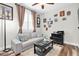 Comfortable living room with couch, black desk, ceiling fan, and window with blinds at 12304 Freesia Ct, Riverview, FL 33569