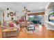 Inviting living room with hardwood floors, large sofa, and a view to the outside at 12304 Freesia Ct, Riverview, FL 33569
