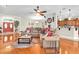 Cozy living room featuring hardwood floors, a ceiling fan, and an open layout to the kitchen at 12304 Freesia Ct, Riverview, FL 33569