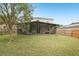 Expansive backyard featuring a screened patio, lush lawn, and mature trees, ideal for outdoor living at 12402 Fairlawn Dr, Riverview, FL 33579