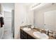 Bathroom featuring double sinks with a large mirror and tile flooring at 12402 Fairlawn Dr, Riverview, FL 33579