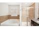 Bright bathroom featuring a soaking tub, glass-enclosed shower, granite countertops, and tile accents at 12402 Fairlawn Dr, Riverview, FL 33579