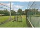 Community batting cage with netting, artificial turf, and pitching machine equipment, great for practice at 12402 Fairlawn Dr, Riverview, FL 33579
