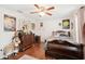 Unique bedroom featuring hardwood floors, vintage-style furniture, and a ceiling fan at 12402 Fairlawn Dr, Riverview, FL 33579