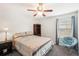 Cozy bedroom featuring a ceiling fan, comfortable bed, and window for natural light at 12402 Fairlawn Dr, Riverview, FL 33579