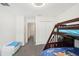 This bedroom features stylish bunk beds, a closet, and access to the hallway at 12402 Fairlawn Dr, Riverview, FL 33579