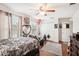 Cozy bedroom featuring hardwood floors, a ceiling fan, and charming decorations at 12402 Fairlawn Dr, Riverview, FL 33579