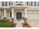 Inviting home entrance with a stylish front door, decorative columns, and well-maintained landscaping at 12402 Fairlawn Dr, Riverview, FL 33579