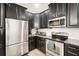 Well-appointed kitchen with black cabinets, stainless steel appliances, and ample counter space at 12402 Fairlawn Dr, Riverview, FL 33579