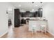 Modern kitchen features dark cabinets, stainless steel appliances, and a breakfast bar at 12402 Fairlawn Dr, Riverview, FL 33579