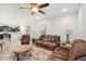 Comfortable living room with brown leather furniture and a view into the open kitchen at 12402 Fairlawn Dr, Riverview, FL 33579