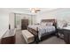 Spacious main bedroom with a large bed, dresser, neutral tones, and ample natural light from the window at 12402 Fairlawn Dr, Riverview, FL 33579
