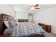 Spacious main bedroom features a wooden bed frame, ceiling fan, and complementary dark wood furniture at 12402 Fairlawn Dr, Riverview, FL 33579