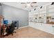 Home office with custom built-in shelving, neutral paint, and tile floors at 12402 Fairlawn Dr, Riverview, FL 33579