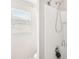 Bright shower with white tile and a hand-held shower head at 12402 Fairlawn Dr, Riverview, FL 33579