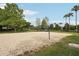 Community sand volleyball court with net, surrounded by grassy areas and mature landscaping at 12402 Fairlawn Dr, Riverview, FL 33579