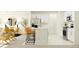This modern kitchen boasts white cabinets, bar seating, and stainless steel appliances at 12613 Aura Moonlight Ter, Parrish, FL 34219