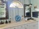 Bathroom featuring double sinks, unique decor, mirrors, and a stylish arched window at 1345 S Evergreen Ave, Clearwater, FL 33756