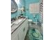 Bright bathroom featuring a modern vanity, decorative mirror, and custom turtle themed decor and accents at 1345 S Evergreen Ave, Clearwater, FL 33756