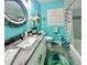 Bright bathroom featuring a modern vanity, decorative mirror, and custom turtle themed decor and accents at 1345 S Evergreen Ave, Clearwater, FL 33756