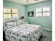 Comfortable bedroom with large windows, ceiling fan, and stylish coral bedding at 1345 S Evergreen Ave, Clearwater, FL 33756