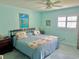 Bright bedroom features plush carpet, ceiling fan, and shutters for optimal natural light at 1345 S Evergreen Ave, Clearwater, FL 33756