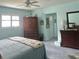 Comfortable bedroom with light blue walls, soft carpet, and a ceiling fan at 1345 S Evergreen Ave, Clearwater, FL 33756