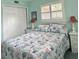 Bright bedroom features plush carpet, closet, and matching bedside tables and lamps at 1345 S Evergreen Ave, Clearwater, FL 33756