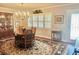 Formal dining area with hardwood floors, chandelier, and an adjacent window creating an inviting atmosphere at 1345 S Evergreen Ave, Clearwater, FL 33756