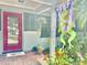 Stylish front door with a vibrant color, surrounded by lush plants and decor creating a welcoming entrance at 1345 S Evergreen Ave, Clearwater, FL 33756