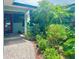 Inviting front porch with a colorful door and lush landscaping that adds curb appeal to this charming home at 1345 S Evergreen Ave, Clearwater, FL 33756