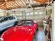 Spacious three car garage with a red convertible parked inside at 1345 S Evergreen Ave, Clearwater, FL 33756