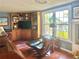 Inviting living room area features a cozy seating area, fireplace and natural light from windows at 1345 S Evergreen Ave, Clearwater, FL 33756