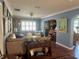 Comfortable living room showing seating, decor, built-in shelving, and wood floors at 1345 S Evergreen Ave, Clearwater, FL 33756
