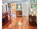 Open living area showcases wood floors, a charming wooden dresser, and vibrant artwork at 1345 S Evergreen Ave, Clearwater, FL 33756