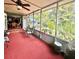 Cozy screened porch with ceiling fan, outdoor seating and view of the yard at 1345 S Evergreen Ave, Clearwater, FL 33756