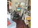 Shed interior featuring a painting on an easel, artwork, wooden floors, and a comfortable chair at 1345 S Evergreen Ave, Clearwater, FL 33756