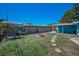 Landscaped backyard featuring a fire pit, wooden fence, and stepping stones at 13970 Montego Dr, Seminole, FL 33776