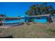 Cozy backyard with pool, wooden deck, and storage shed on sunny day at 13970 Montego Dr, Seminole, FL 33776