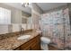 This bathroom features a tiled shower with a nautical themed shower curtain at 13970 Montego Dr, Seminole, FL 33776