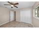 This bedroom features tile floors, a ceiling fan, and closet with bi-fold doors at 13970 Montego Dr, Seminole, FL 33776