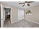 This bedroom features tile floors, a ceiling fan, and closet with bi-fold doors at 13970 Montego Dr, Seminole, FL 33776